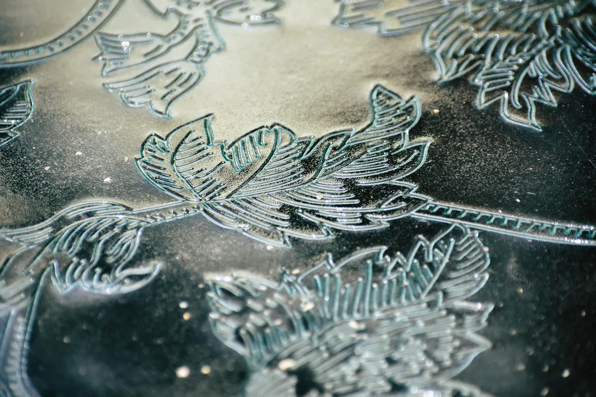 A detailed antique print being examined